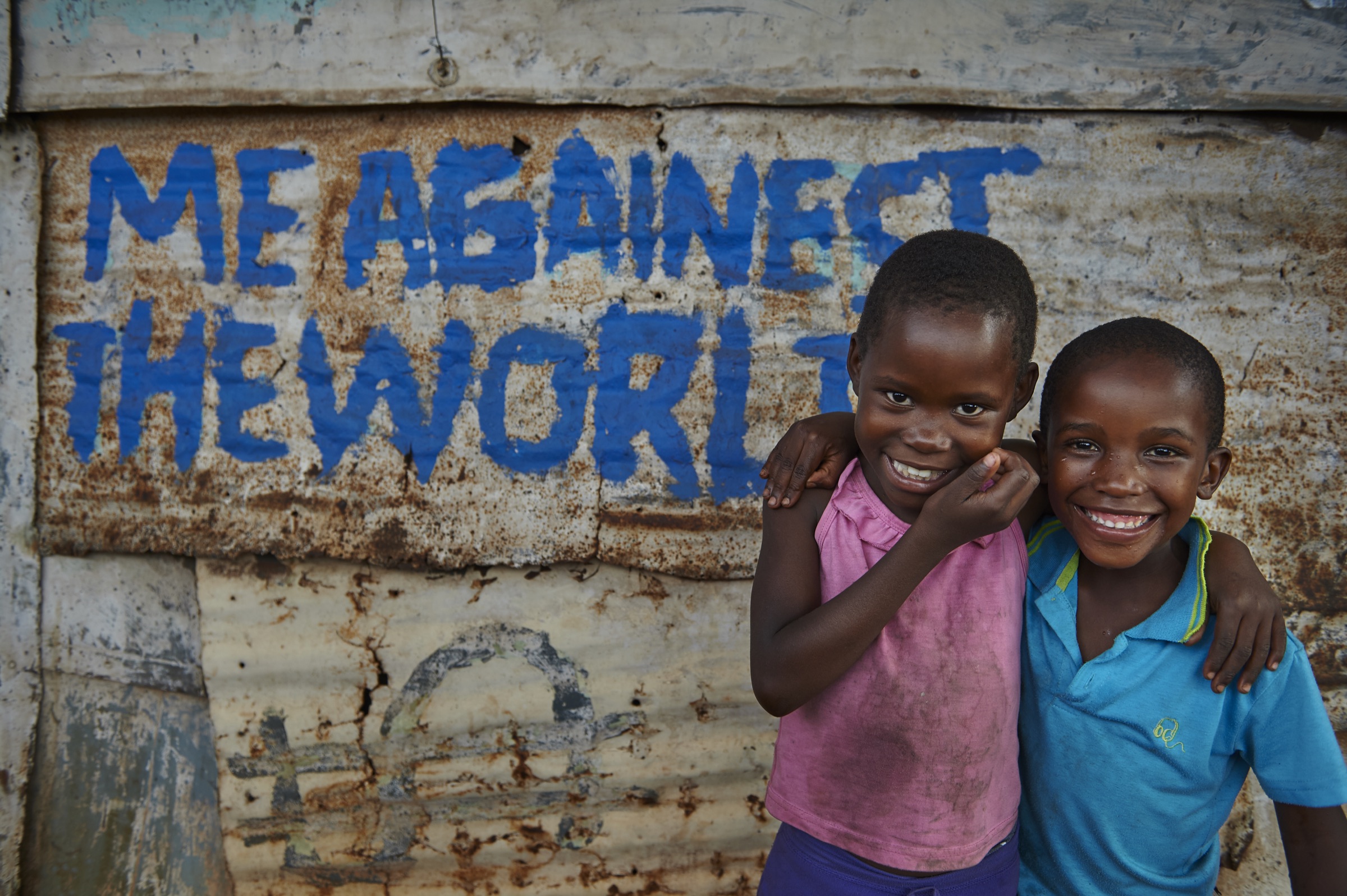 Two children standing together in their community
