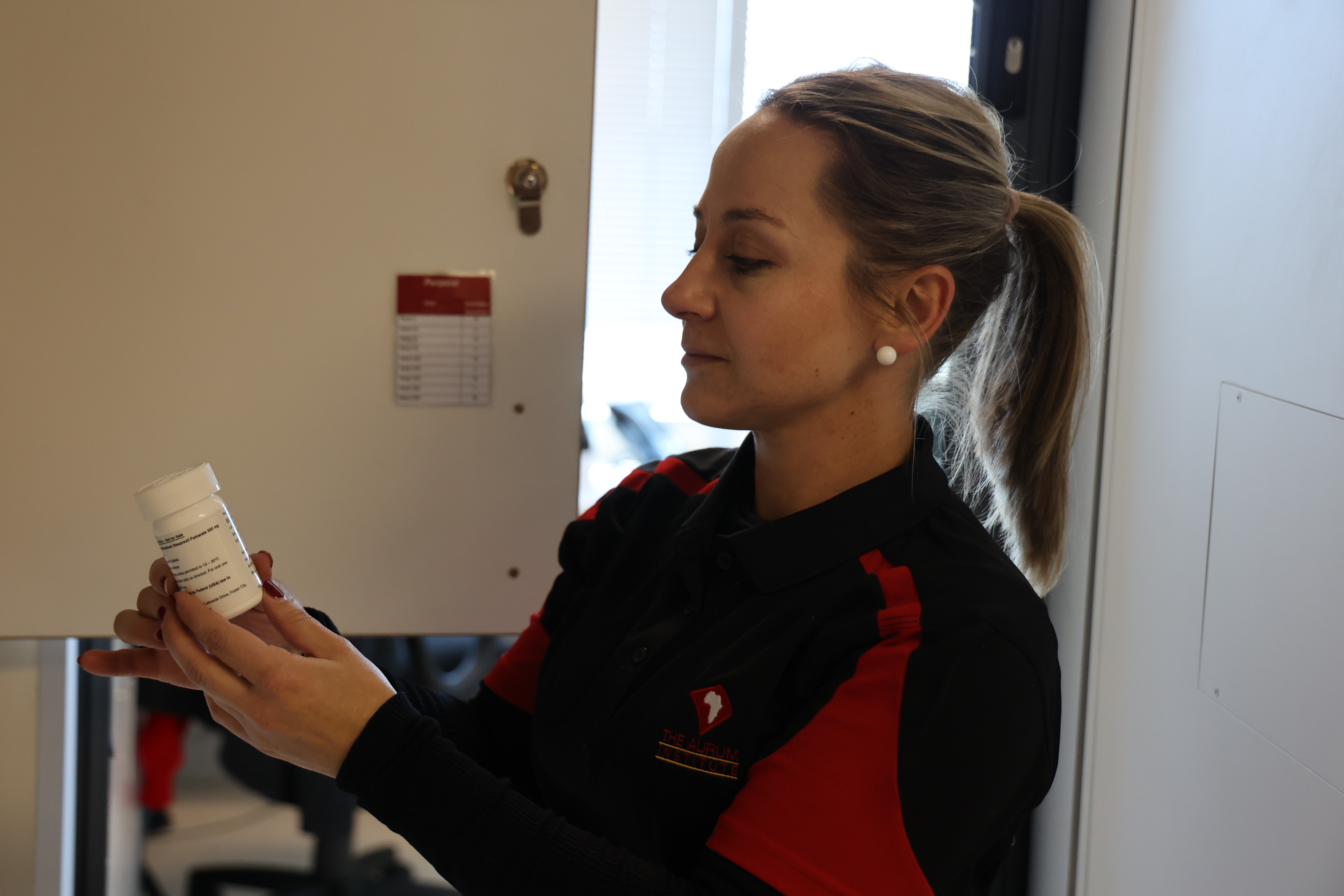 An Aurum staff member checking labelled research medication