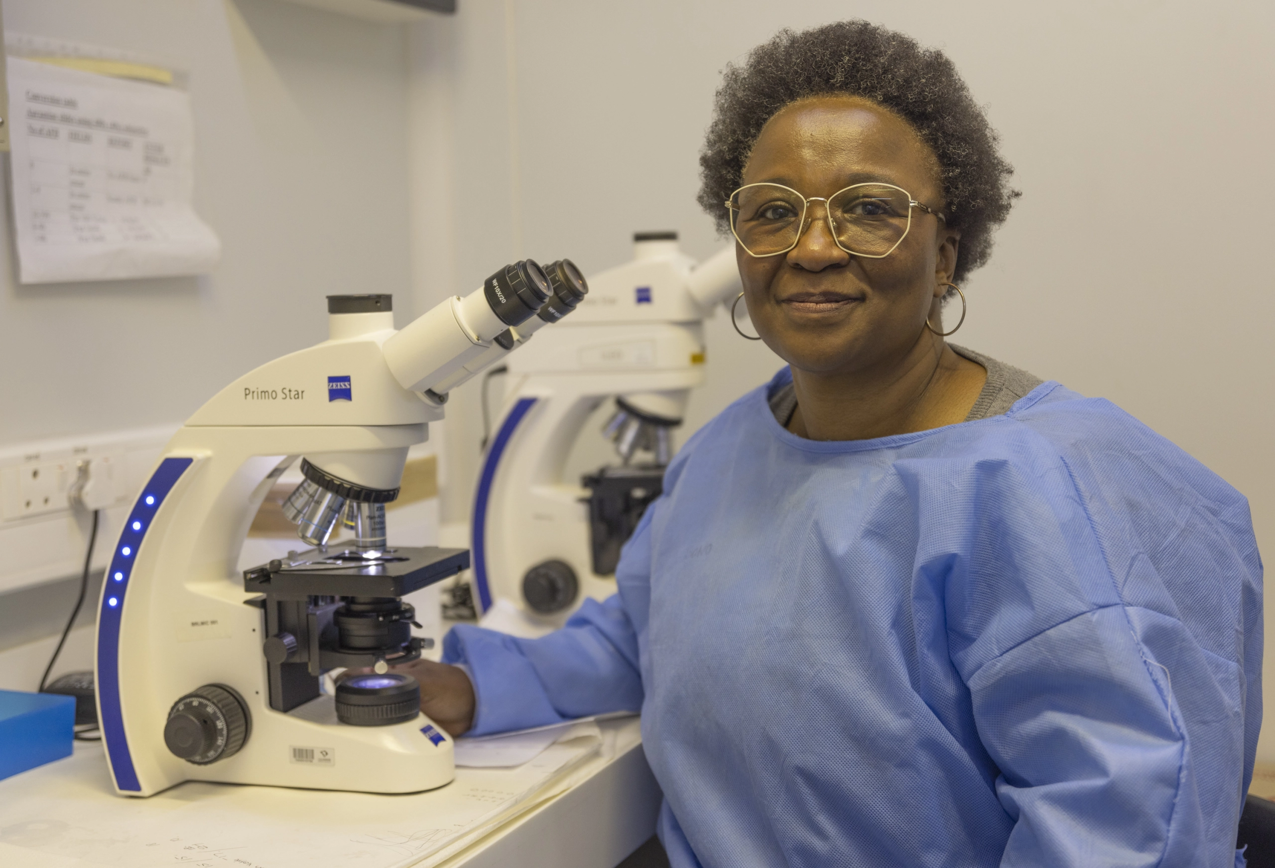 A Biomedical Research Laboratory researcher working at a microscope