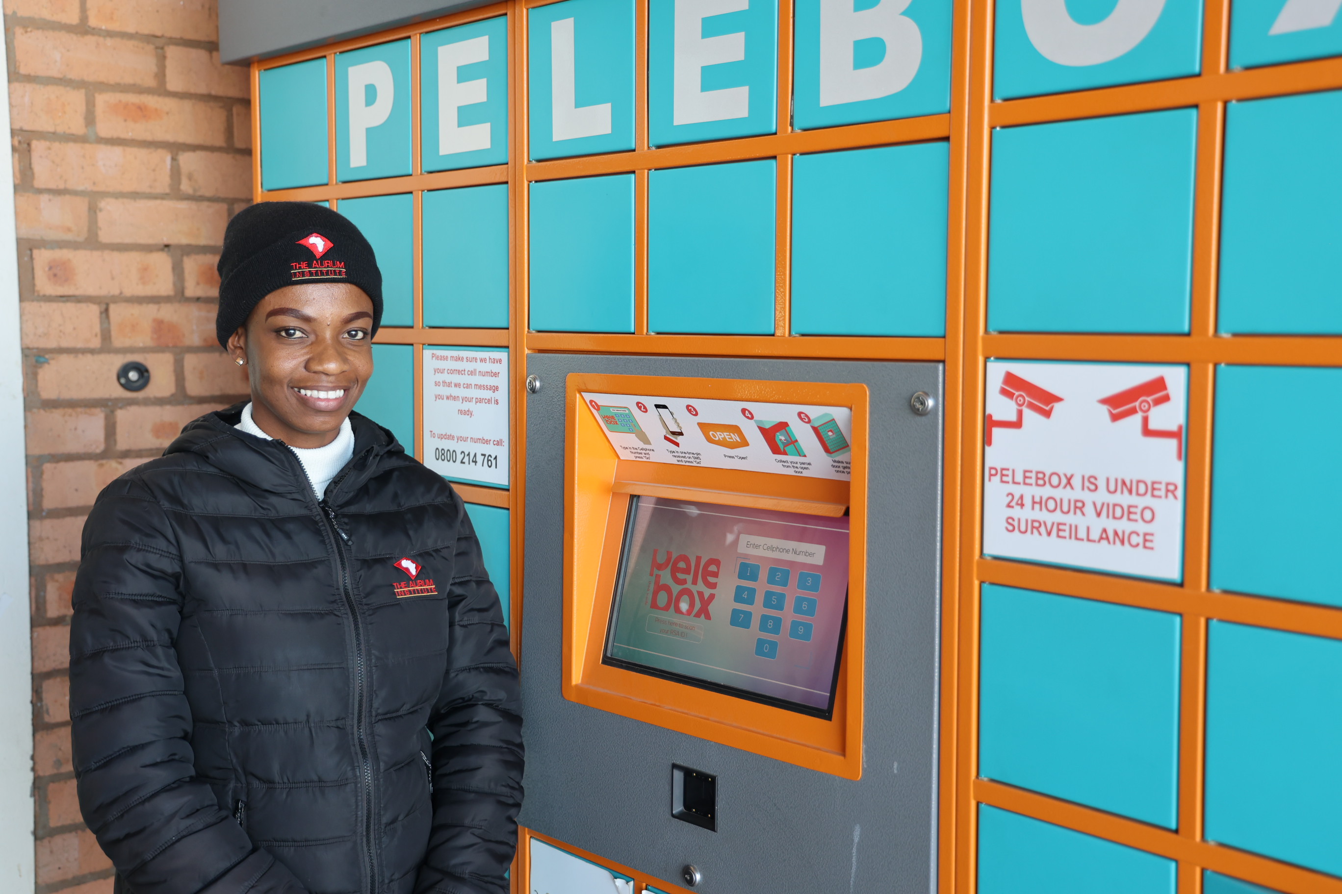 An Aurum staff member standing beside a Pelebox collection point